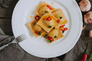 Itallian food. Home ravioli with prawns, garlic and chili pepper.