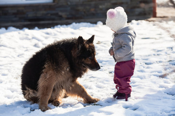 Girl meets a dog on winter walk
