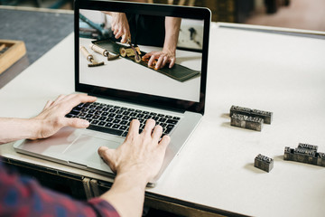 Crop man watching tutorial video