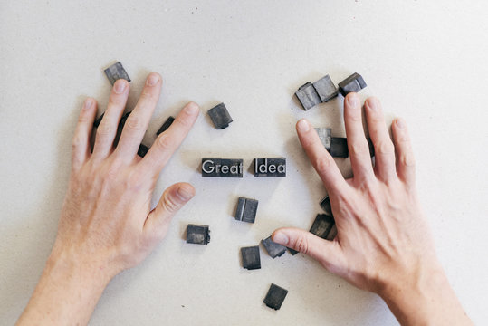 Crop man arranging printing letters