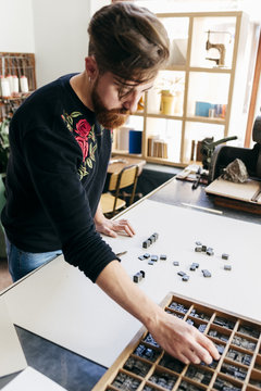 Worker arranging printing letters