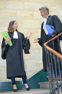 male and female lawyers talking in stairs