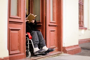 Fototapeta na wymiar Lonely old woman reading a book