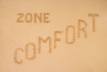 Comfort zone concept. The inscription is made on a brown blanket