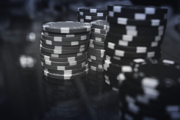 Poker black chips and cards on the table  in a black a white. Vignetting effect