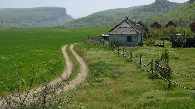 Ukrainian historic house with a rural road