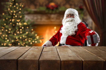 Santa Claus at the table where you can place an advertising product or text 