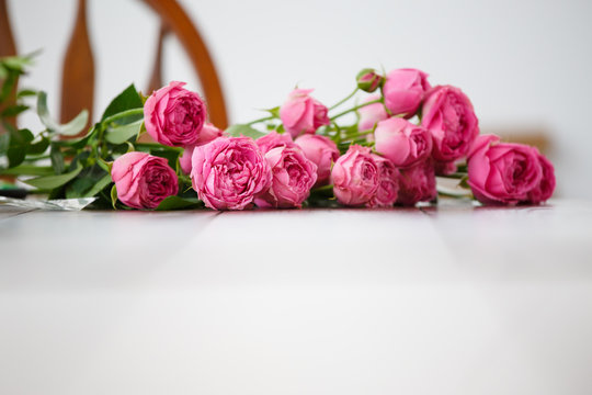 Image of pink peonies on white wooden table