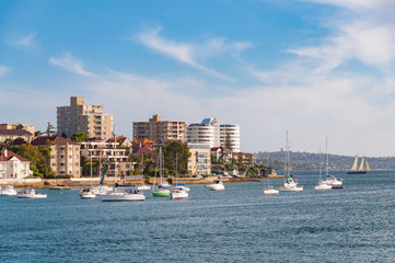 Fototapeta na wymiar Urban coastline with waterfront property and yachts