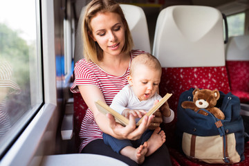 Young mother travelling with baby by train. © Halfpoint