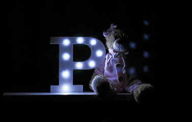 Letter P with dark light in room - obrazy, fototapety, plakaty