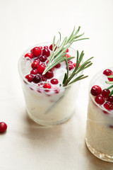 Perfect christmas cocktail: coconut margarita with cranberries and rosemary. Minimalistic concept. Linen cloth and white background. Close up view.