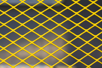 Yellow metal grid on the dark background.