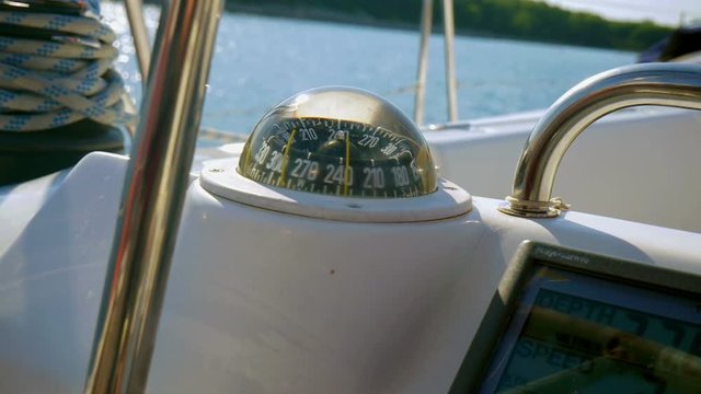 Looking on sailing boats compass through steering wheel in slow motion hd. Filmed on sailing trip in Adriatic sea.