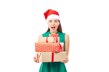 Portrait of young womanin Santa hat holding stack of Christmas gifts on white background
