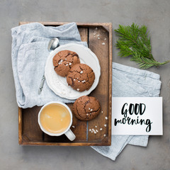 Fototapeta premium The perfect tasty breakfast!) Chocolate chip cookies with dark chocolate and sea pink Himalayan salt and cup of coffee on a gray concrete background. Best Brown Butter Cookies. 