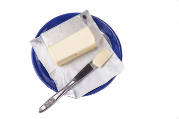 Butter on the blue plate  on the white background.