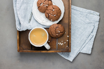 The perfect tasty breakfast!) Chocolate chip cookies with dark chocolate and sea pink Himalayan salt and cup of coffee on a gray concrete background. Best Brown Butter Cookies. 