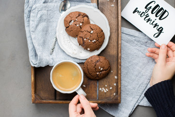 The perfect tasty breakfast!) Chocolate chip cookies with dark chocolate and sea pink Himalayan salt and cup of coffee on a gray concrete background. Best Brown Butter Cookies. 