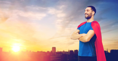 man in red superhero cape over city background © Syda Productions