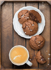The perfect tasty breakfast!) Chocolate chip cookies with dark chocolate and sea pink Himalayan salt and cup of coffee on a gray concrete background. Best Brown Butter Cookies. 