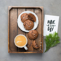 The perfect tasty breakfast!) Chocolate chip cookies with dark chocolate and sea pink Himalayan salt and cup of coffee on a gray concrete background. Best Brown Butter Cookies. 
