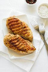 Grilled chicken breast on white table cloth © thayra83