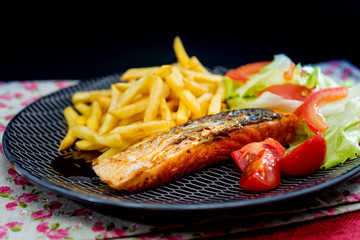 grilled salmon with sauce lemon and tomato