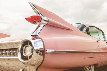 Rear end of a pink classic car