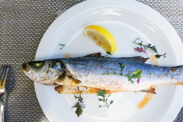 grilled salmon and lemon - french cuisine dish with tomato and salmon