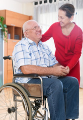 Fototapeta na wymiar Loving wife next to her husband in wheelchair