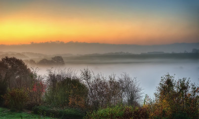 Fototapeta na wymiar Sunrise over morning mist, Aachen, Germany
