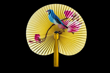 Closeup of Traditional Chinese fan on black background.