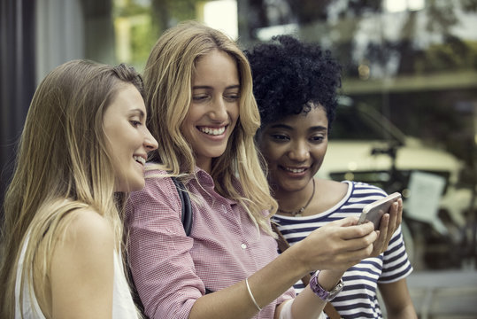 Friends using smartphone to take a selfie