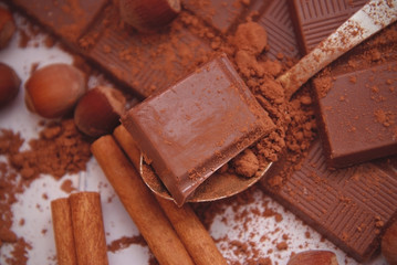 Closeup of Cocoa Powder and Dark Chocolate with Cinnamon, Cocoa Powder. Ingredients for Preparation of Dessert. Recipie Background.