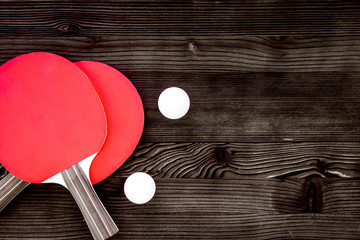Red racket for ping pong ball wooden background top view