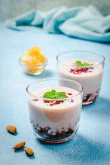 Over night oatmeal citrus pomegranate and yogurt . Healthy breakfast. Selective focus, copy space.