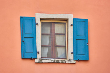 Fototapeta na wymiar Old wooden window shutters of an mediterranean house,Italian Window with Open Wooden Shutters