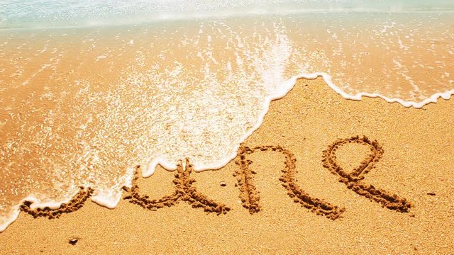 	Inscription of the name of month on sand, the beach.