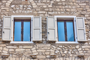 Old wooden window shutters of an mediterranean house,Italian Window with Open Wooden Shutters