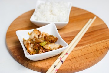 Chinese food with rice in small square bowls with chopsticks