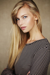 Fototapeta premium Stunning young blond woman in striped top, portrait