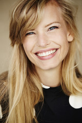 Young grinning blond girl looking at camera