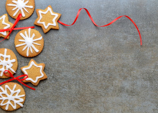 Festive cookies on stone background with red ribbon
