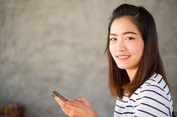 Portrait of Asian girl using telephone