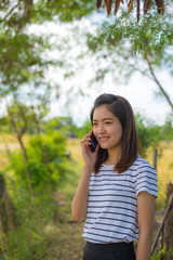 Fototapeta premium Portrait of asian girl talking on telephone