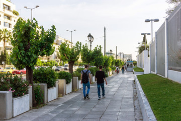 Fototapeta na wymiar ATHENS, GREECE - May 3, 2017: Tourists on foot Graben Street in Athens, Greece