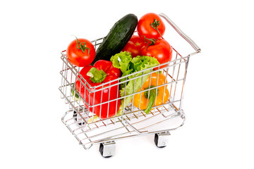 Miniature cart with vegetables on a white background