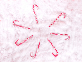 red white candy lollipop on white snow