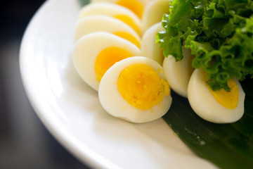 Sliced boiled egg on a white plate